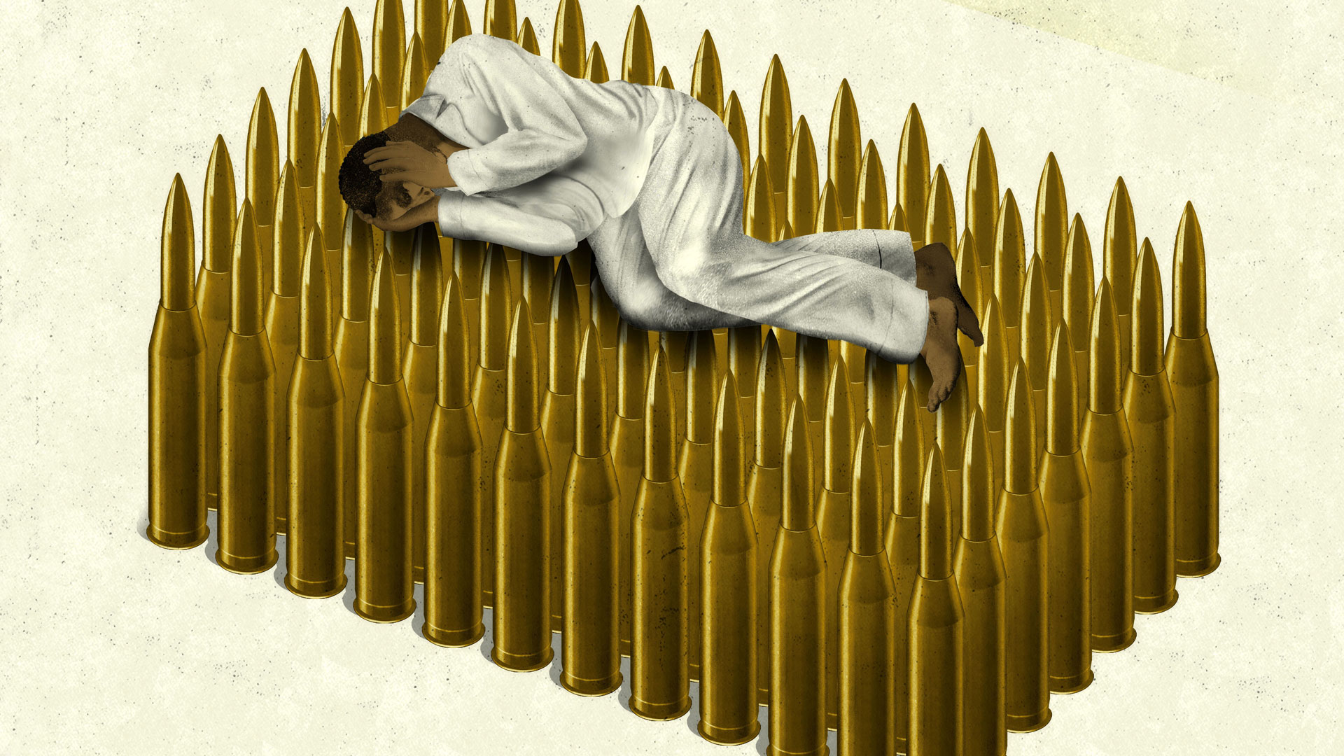 Person lying on circular arrangement of bullet cartridges